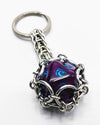CAGED D20 KEYCHAIN (DRAGONS MANA)